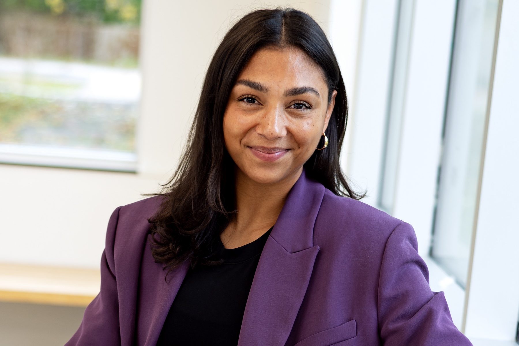 VP Patrick posing in a purple blazer.