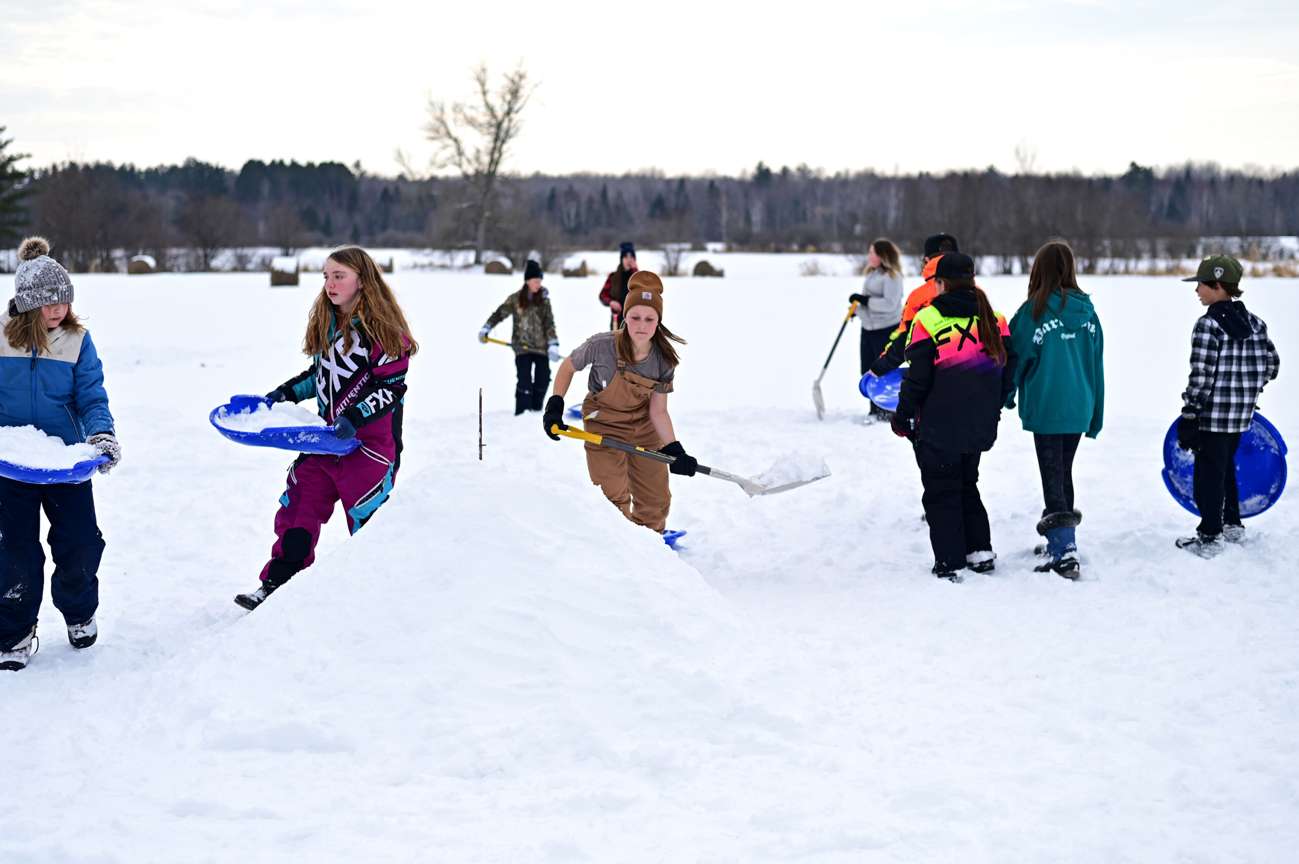 Students building quinzees in teams