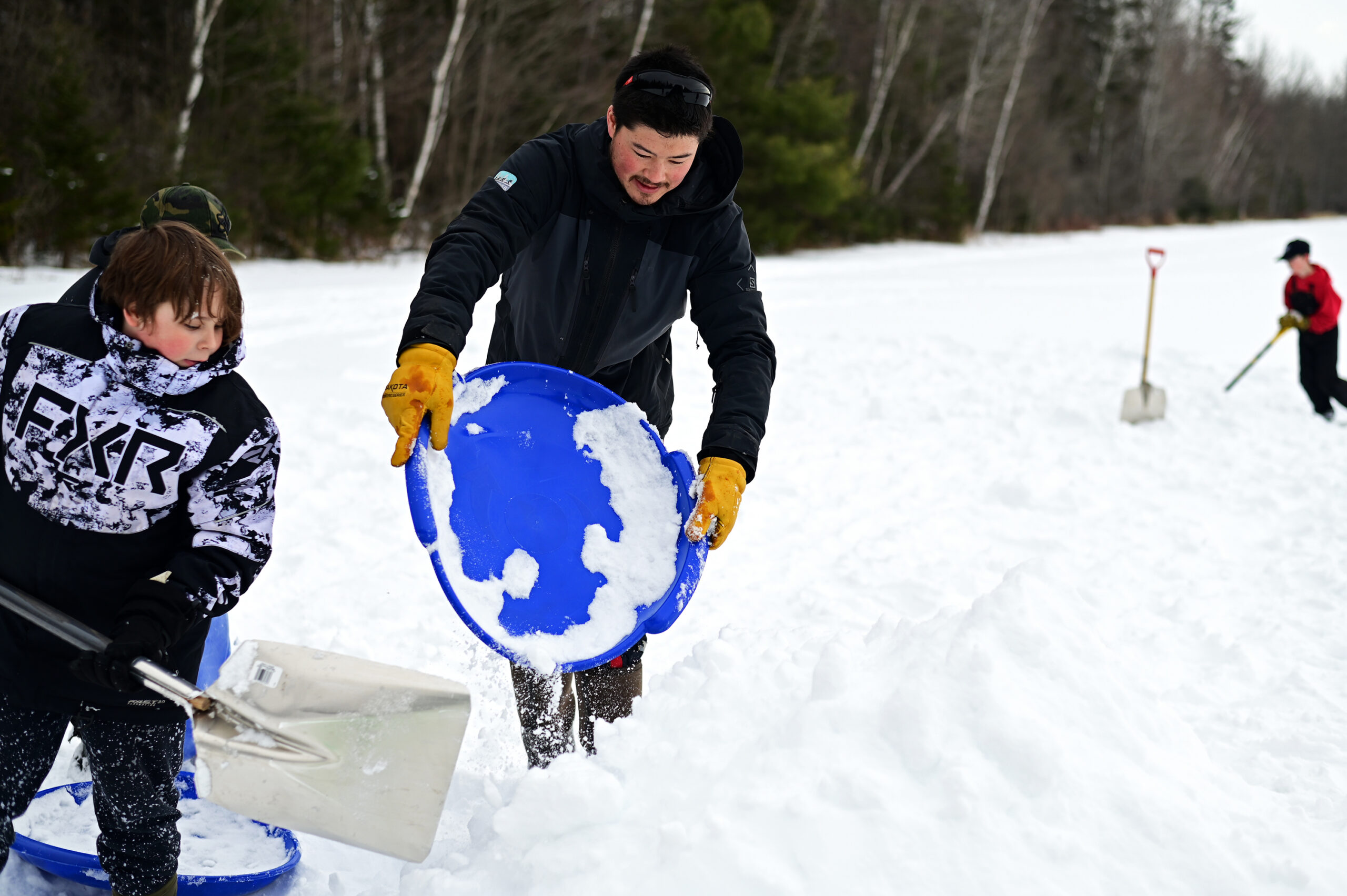 Mr. Fong helping to build the quinzees alongside the studetns