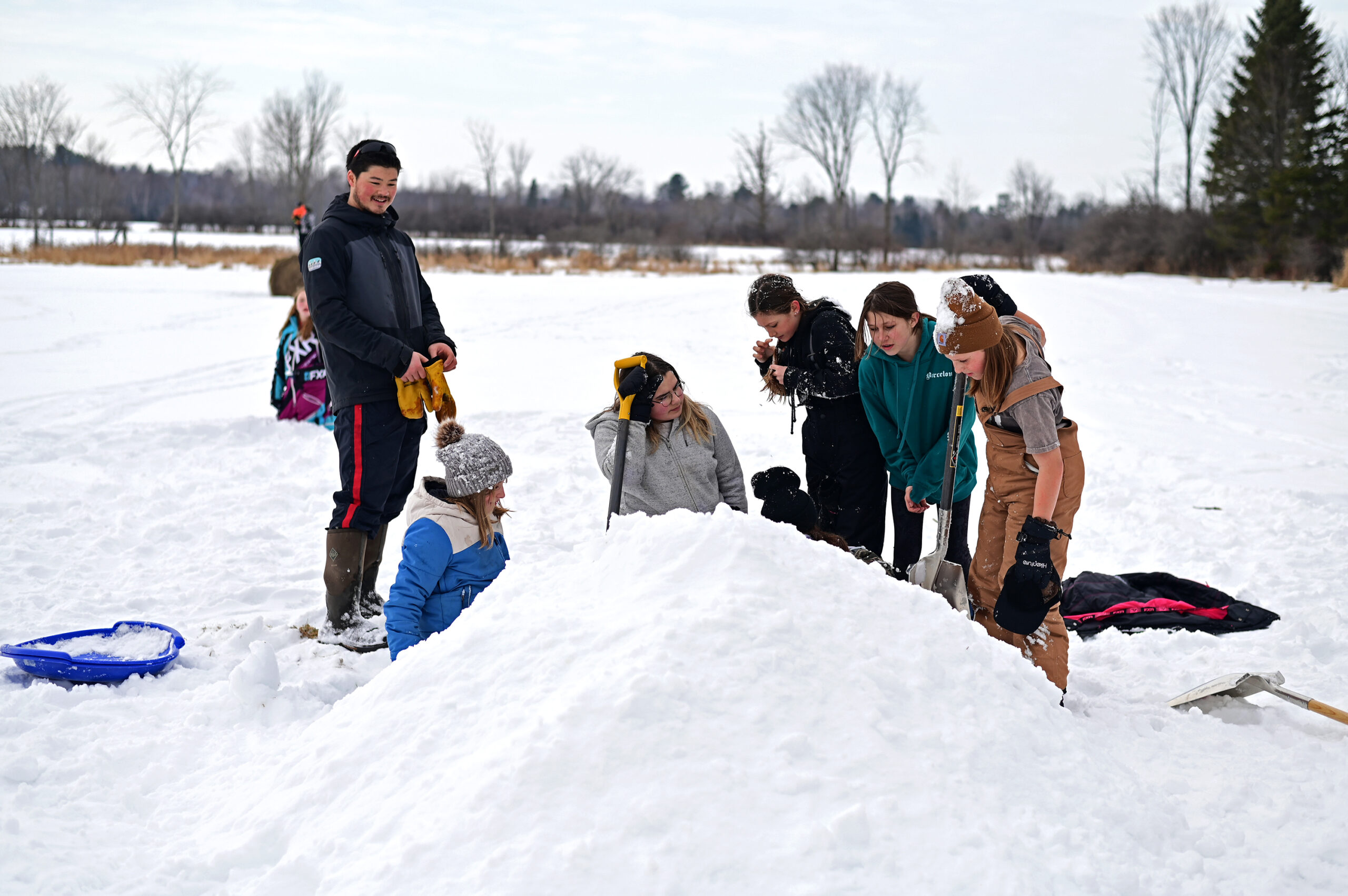 Mr. Fong and students smilling at the quinzee coming together
