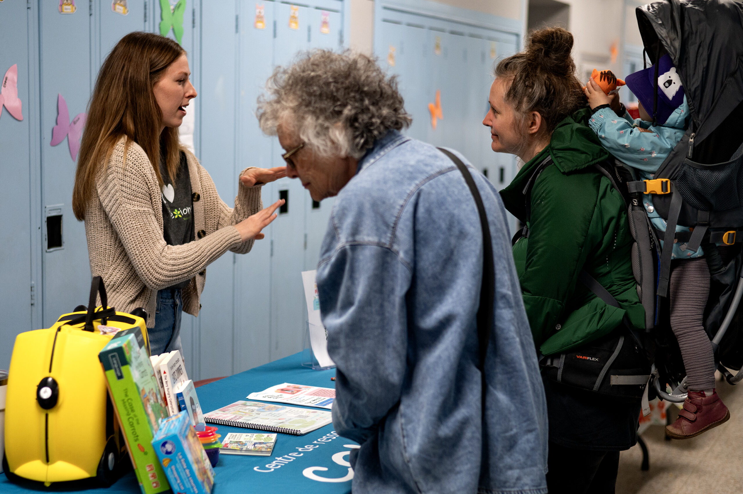 The connexions table set up inside with attendees looking and speaking to the representative