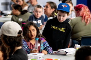 Two students enjoy the sensory toys at the table