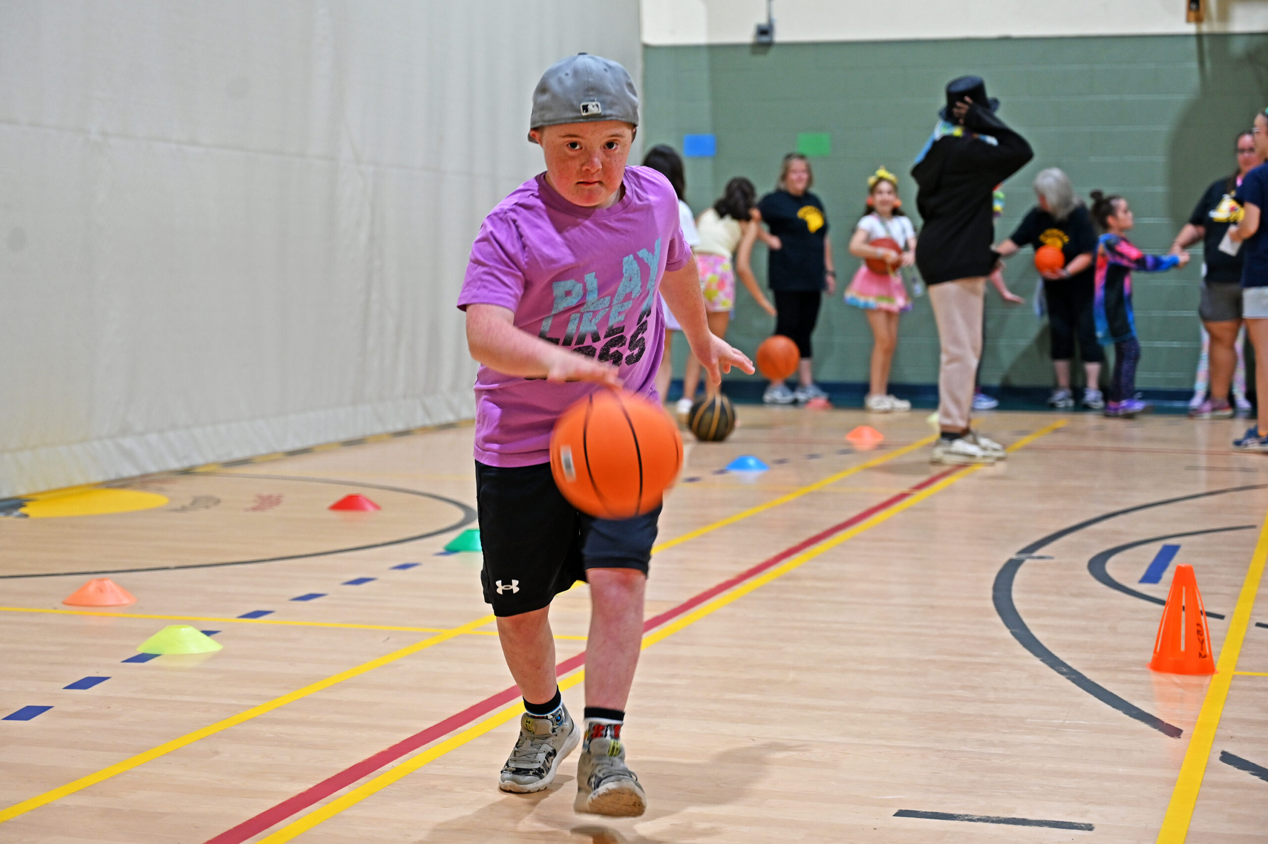 Student dribbling a basketball in the gym
