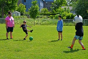 Students playing soccer baseball