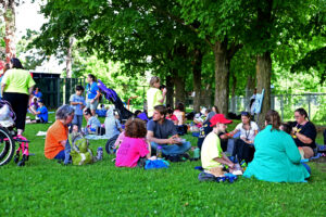Visiting schools eating lunch under the trees