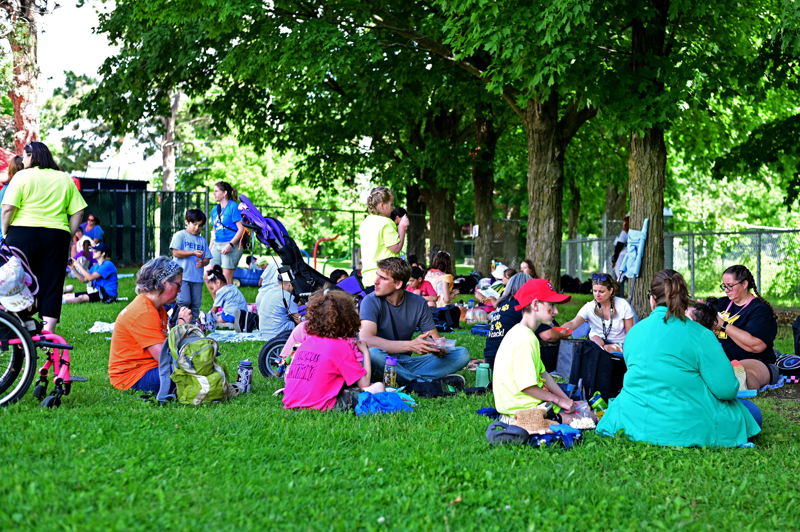 Visiting schools eating lunch under the trees