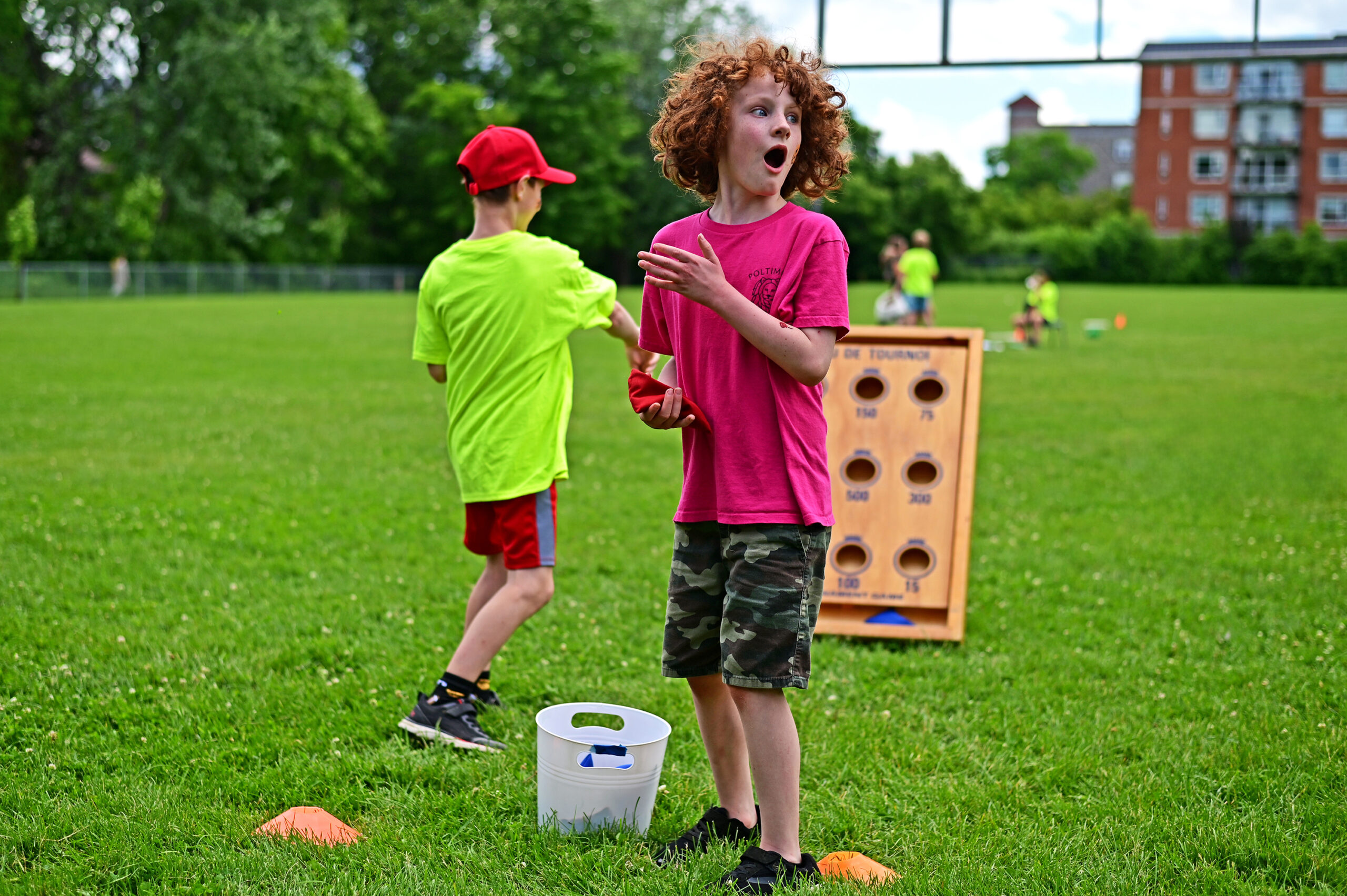 Poltimore student thoroughly enjoying the sandbag toss with big eyes