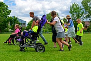 Staff members assist students in the final race