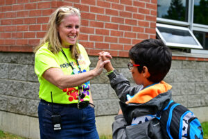 Principal Julia Horner high-fives a grateful PETES student