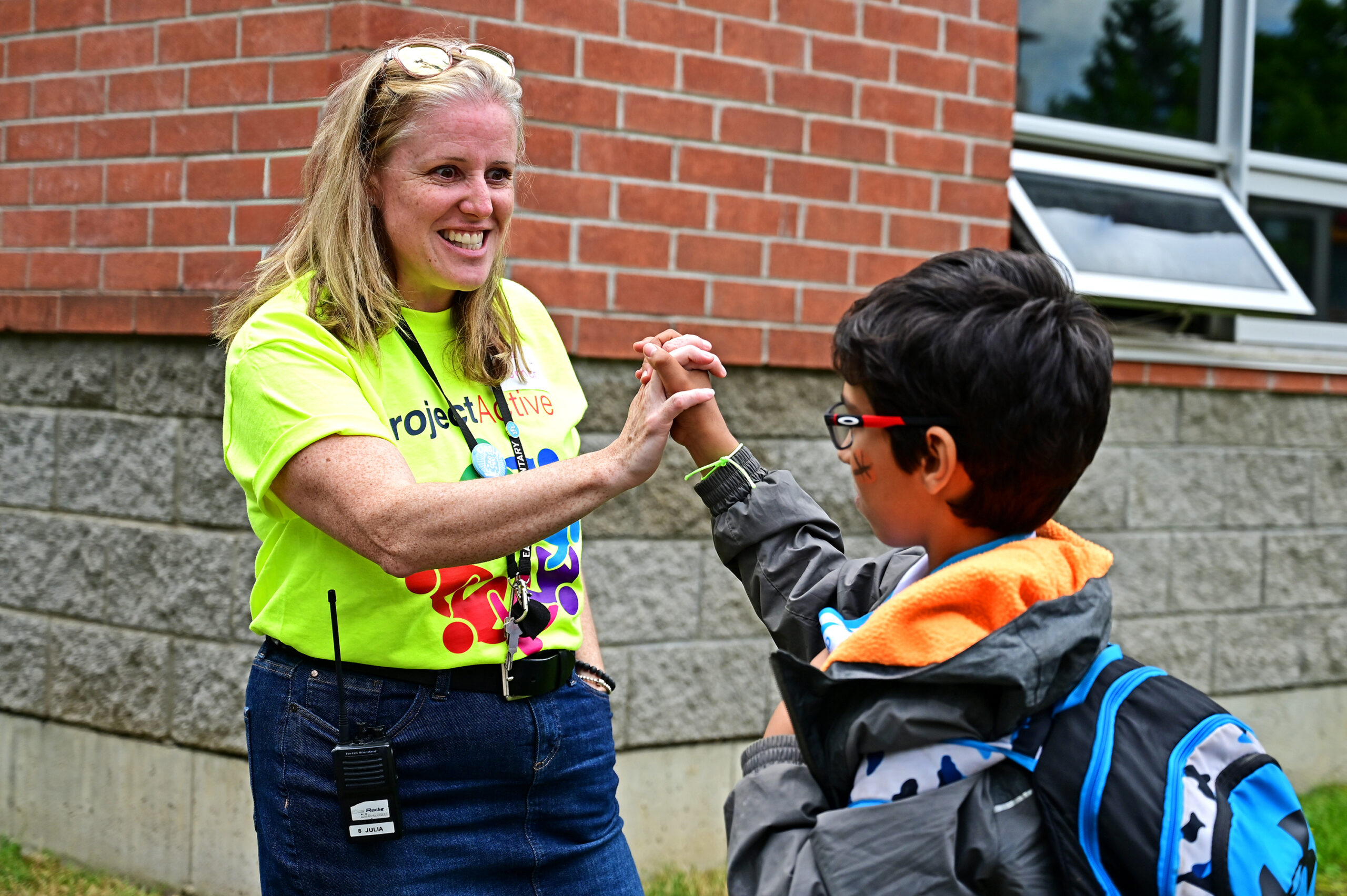 Principal Julia Horner high-fives a grateful PETES student