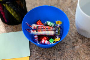 Candy in a blue bowl at one of the tables