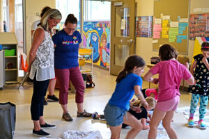 Staff members overlooking the students' colouring